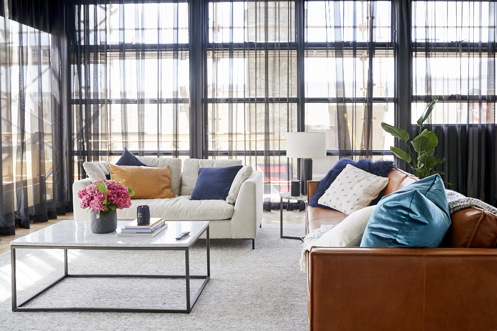  Bianca and Carla created a stunning living room with contrast couches and a selection of plain and on-trend cushions. 