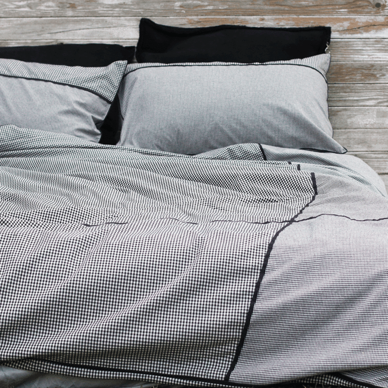 The Alyx quilt cover set features both a large scale and small scale Gingham that has been spliced together and finished with piping on the front. The under side of the cover is the smaller scale Gingham, available now through The Block Shop