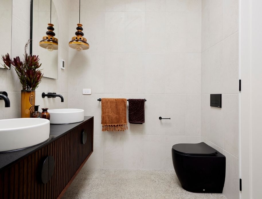 Tanya and Vito Block master ensuite with brown tiles and a black toilet 