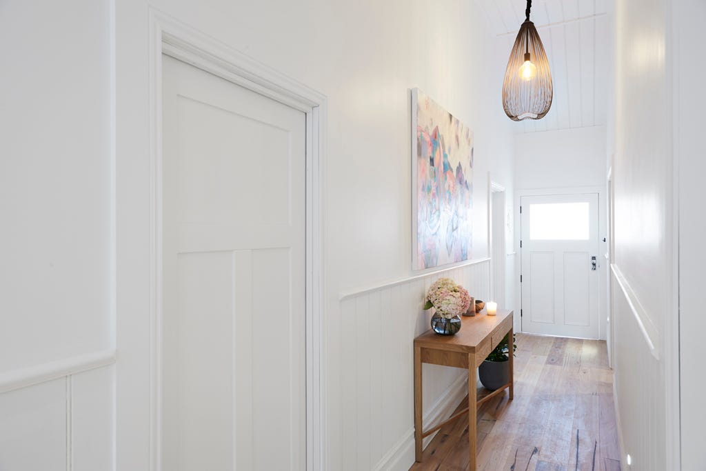 The use of a striking pendant that draws the eyes northwards, to the stunningly executed wood panelling on the ceiling